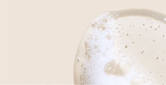 Smiling woman holding smiling toddler