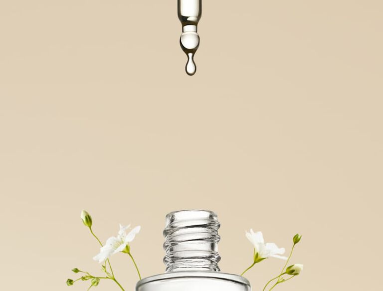 bottle with flowers growing around it