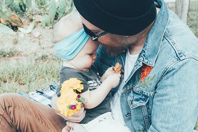 Father kissing baby girl on the forehead