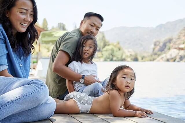 Family of four hanging out at the pier near the lake